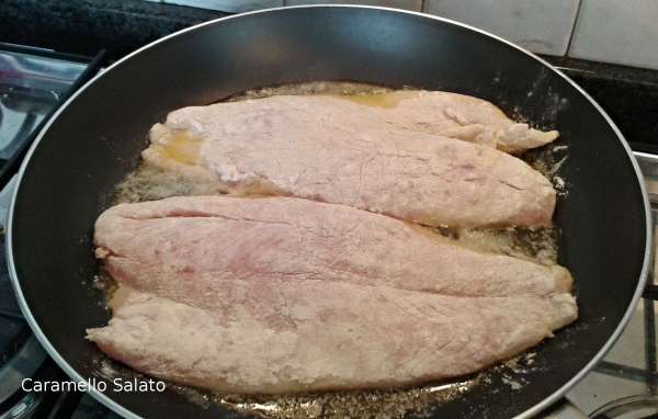 Far sciogliere il burro in un'ampia padella e disporvi i filetti di persico infarinati